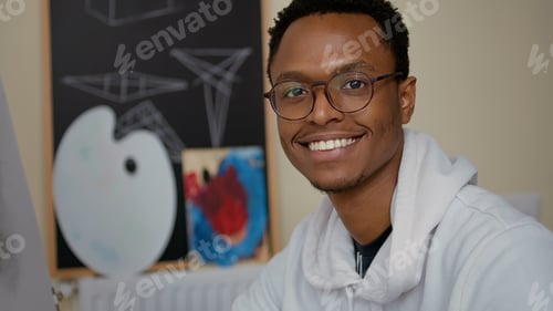 Preview: Portrait of smiling man drawing vase sketch on white canvas