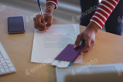 Preview: Businesswoman signing documents on desk in office
