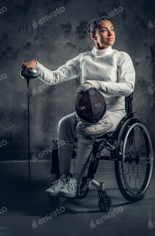 Preview: Female fencer in wheelchair holds safety mask and a sword.