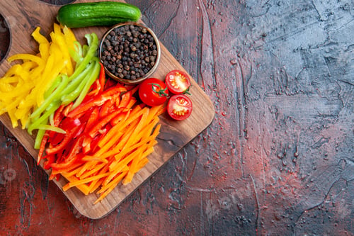Preview: top view colorful cut peppers black pepper tomatoes cucumber on chopping board on dark red table