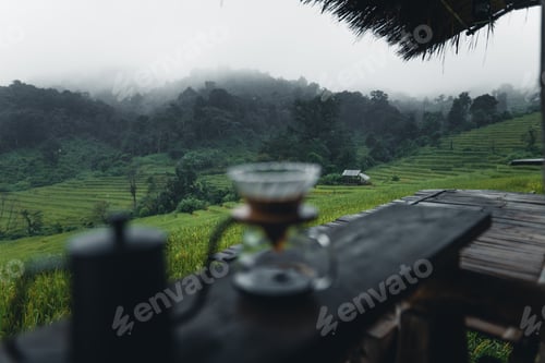 Preview: outdoor drip coffee maker on wooden table rice field background