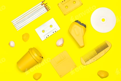 Preview: Bright yellow collection of everyday objects arranged creatively on a vibrant background