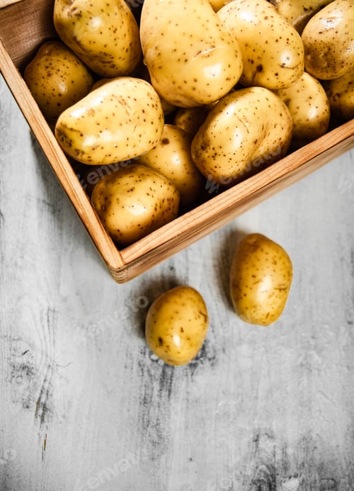 Preview: Fresh potatoes. On white table.