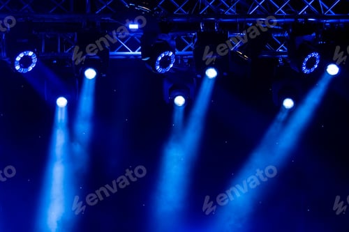 Preview: blue luminous rays from concert lighting against a dark background, musical instrument concept