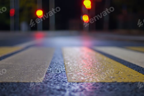 Preview: crosswalk at night street, blurred traffic lights, defocused city background