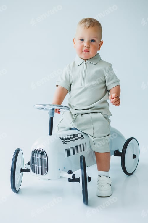 Preview: A charming and adorable young toddler is enjoying a delightful moment while sitting in a stylish