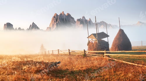 Preview: Amazing mountain landscape with fog and a haystack in autumn