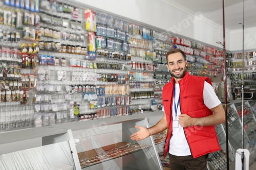 Preview: Salesman standing near showcase with fishing equipment in sports shop. Space for text