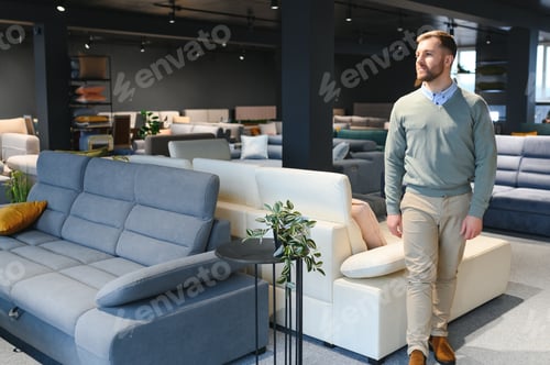 Preview: man chooses furniture in a store