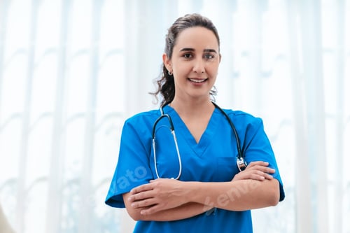 Preview: Smiling Female Doctor in Blue Scrubs