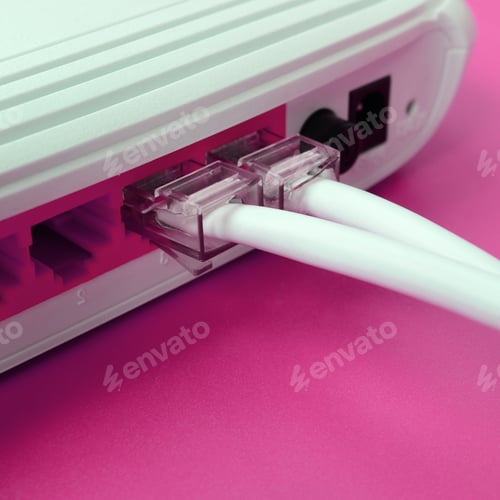 Preview: The Internet cable plugs are connected to the Internet router, which lies on a bright pink backgrou