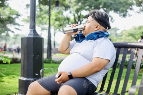 Preview: Fat Man In Sportswear Drinking Water on Bottle After Doing Jogging
