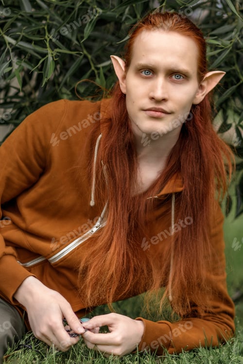 Preview: Artistic elf man with red hair and green eyes in the forest