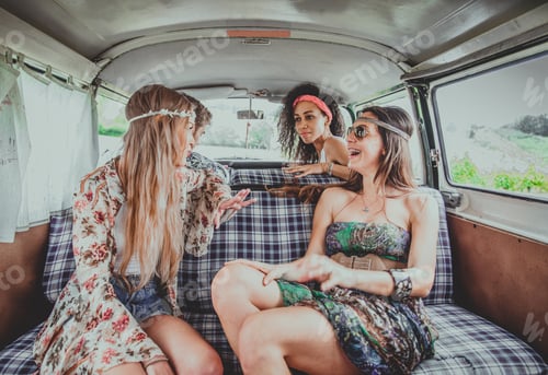 Preview: Happy friends driving a vintage minivan