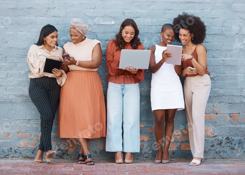 Preview: Group of five young happy cheerful businesswomen standing against a wall outside in the city and us