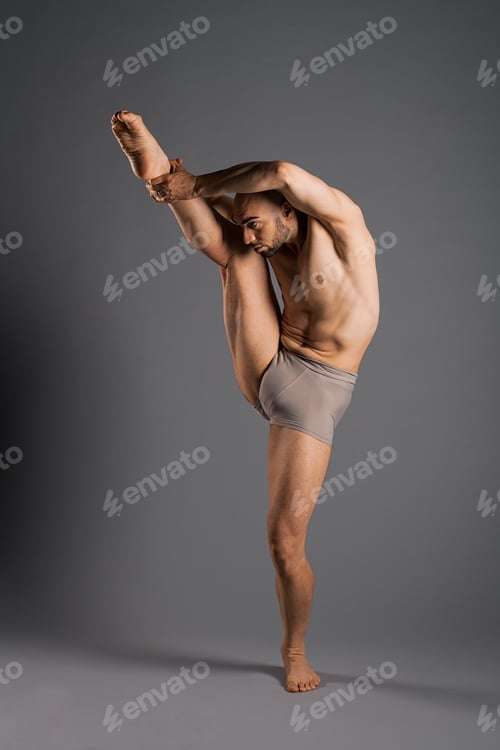 Preview: Male Dancer Performing a Vertical Leg Hold Pose in Studio
