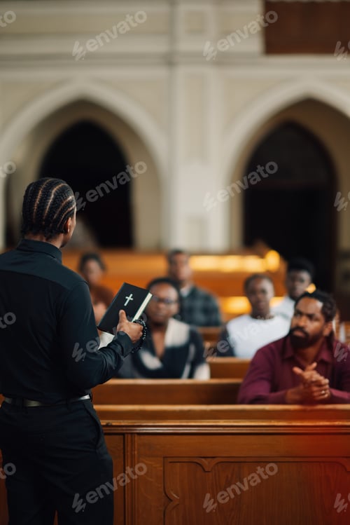 Preview: Pastor preaching and holding bible in church from behind