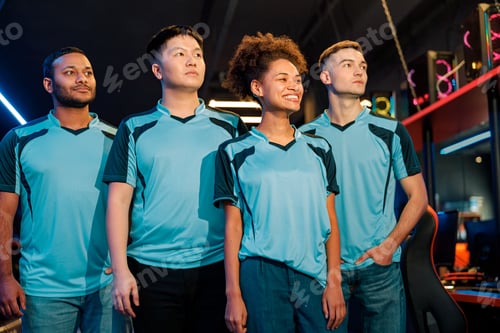 Preview: Multiethnic esports team posing at camera in cyber club