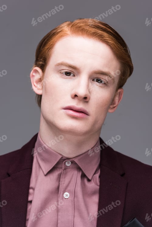 Preview: Portrait of male fashion model dressed in jacket isolated on grey