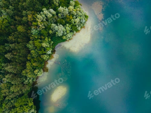 Preview: Aerial drone top down view of lake among forest with beautiful turquoise water in summer day.