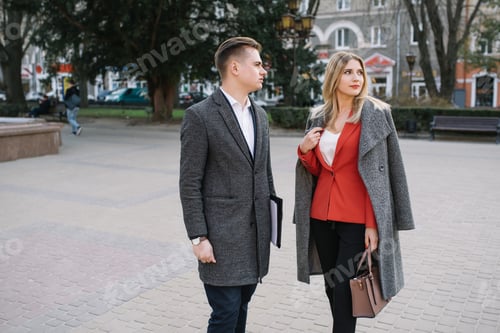 Preview: Business people walking and talking in the street.