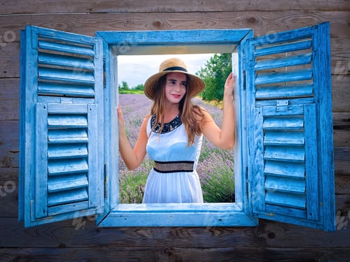 Preview: Woman wearing straw hat and white dress surrounded by lavender flowers looking out through a window