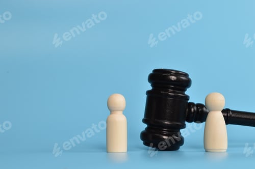 Preview: Wooden doll figures standing with judge gavel. Bribery and corruption concepts