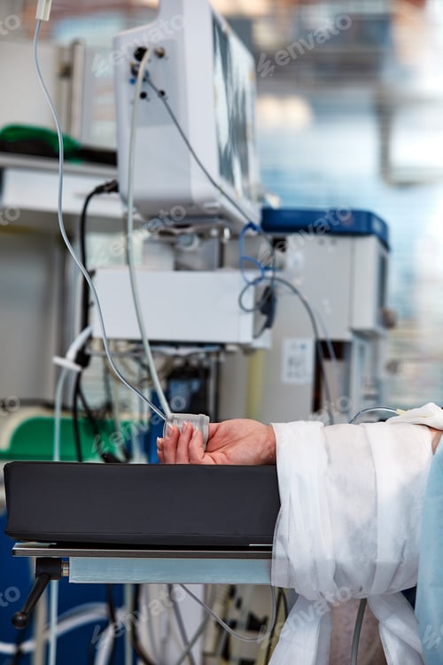 Preview: The patient's hand is under the IV with a pulse oximeter on the finger. Medical services.