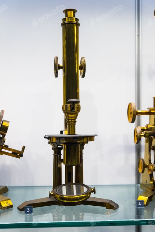 Preview: Big Golden Microscope On A Glass Table