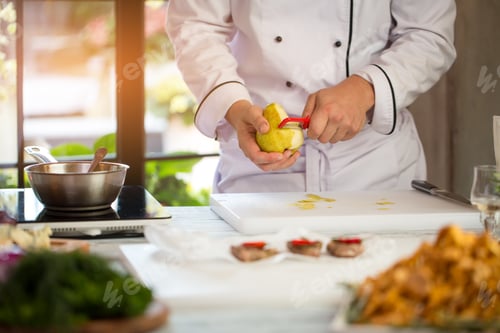 Preview: Man's hand peeling a pear