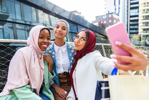 Preview: Beautiful muslim girl wearing hijab bonding outdoors
