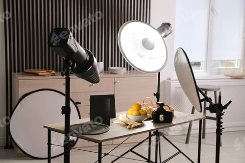 Preview: Professional camera and composition with ripe lemons on table in photo studio. Food photography
