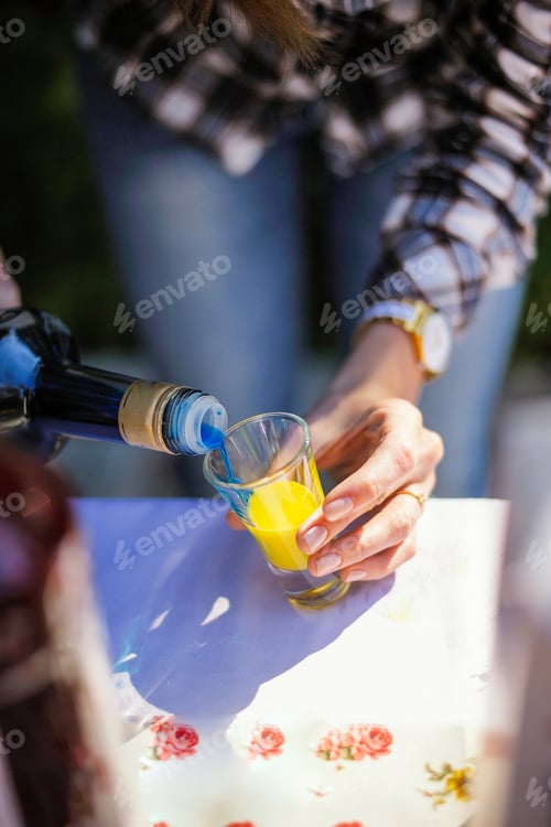 Preview: colorful multicolored layered cocktails in summer outdoors on a sunny bright day. cooking