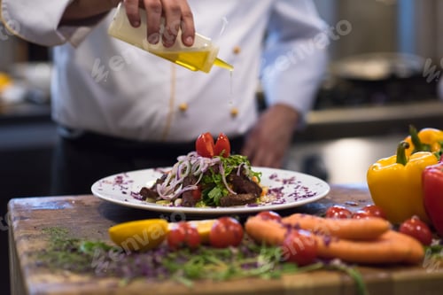Preview: Chef finishing steak meat plate