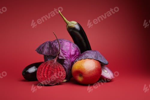 Preview: close-up view of ripe organic apple, cabbage, eggplants, onion and beetroot on red background