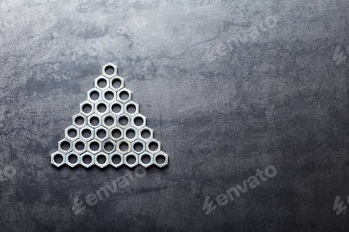 Preview: Triangle from screw nuts on metal texture background