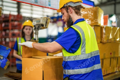 Preview: Warehouse worker folding paper box for packing the items in a large warehouse
