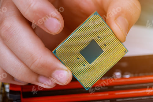 Preview: Computer technician installing CPU into motherboard. Close up. installed in PC motherboard.