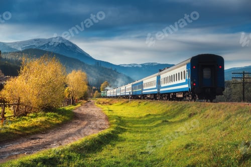 Preview: Moving train in mountains at sunset in autumn