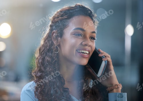 Preview: Cropped shot of an attractive young businesswoman making a phonecall while standing in her office