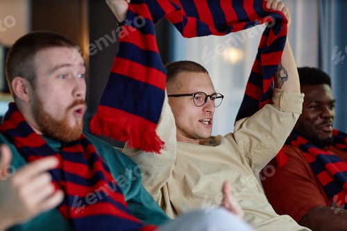 Preview: Man Cheering Holding Scarf in Team Colors