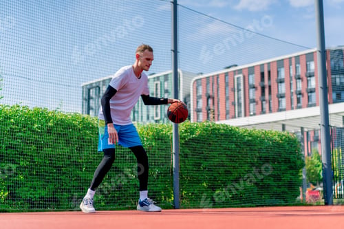 Preview: Tall guy basketball player with the ball shows his dribbling skills during practice