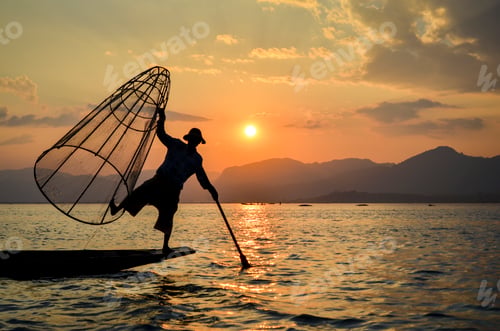 Preview: A fisherman balancing on one leg on a boat, traditional fishing