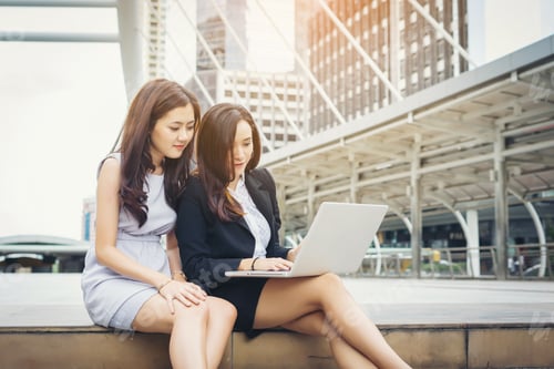 Preview: Two Women Working Together in an Urban Setting