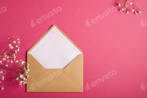 Preview: Kraft brown paper envelope with white empty card, gypsophila flowers