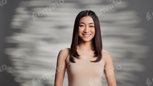 Preview: Asian model with glowing look posing for beauty ad
