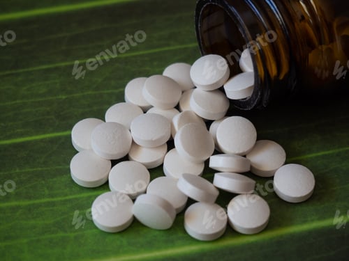 Preview: White tablets on green background