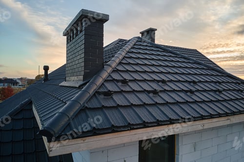 Preview: Snow guard for safety in winter on house roof top covered with steel shingles.