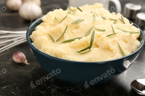 Preview: Bowl with tasty mashed potato on dark table