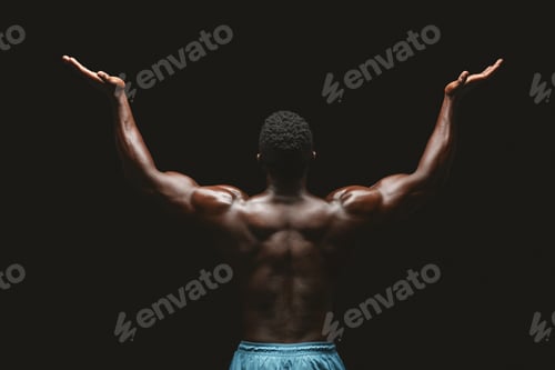 Preview: Back view of black bodybuilder raising his hands up